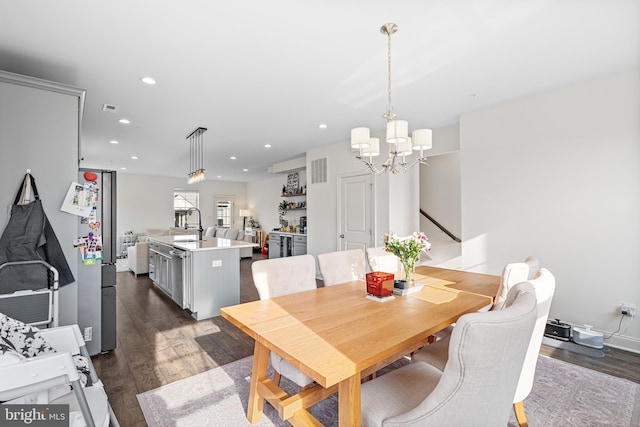 dining room with a notable chandelier, dark wood-style flooring, visible vents, and recessed lighting