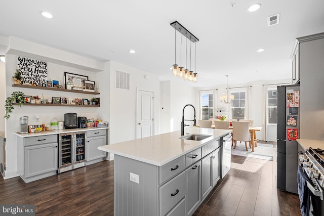 kitchen featuring stainless steel appliances, wine cooler, a sink, and gray cabinetry