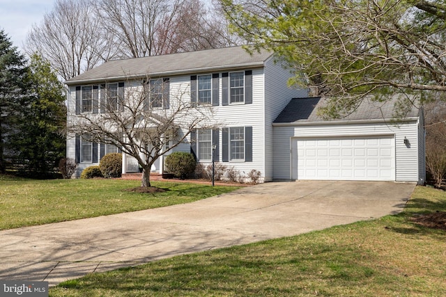 colonial-style house featuring driveway, an attached garage, and a front yard