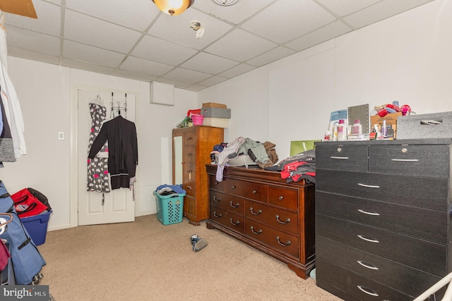 bedroom featuring a paneled ceiling and light colored carpet