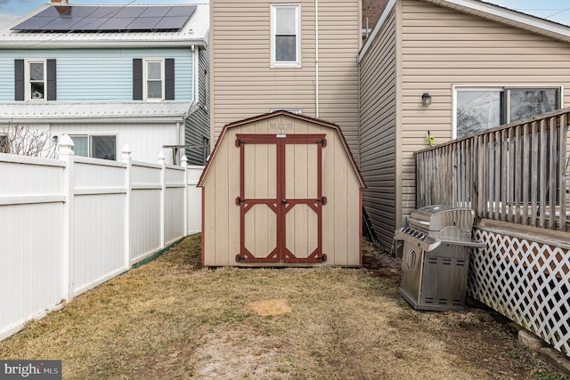 view of shed featuring fence