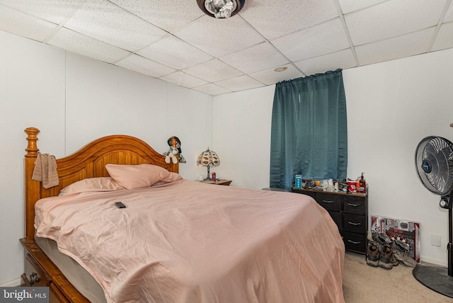 carpeted bedroom with a drop ceiling