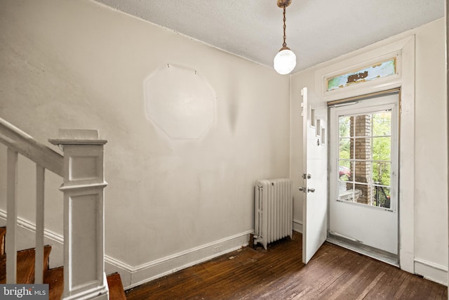 interior space with radiator, stairs, baseboards, and dark wood-type flooring