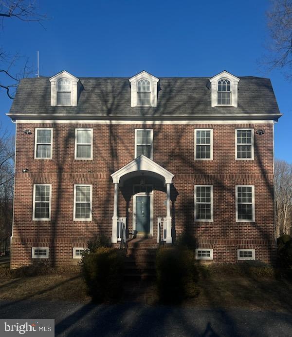 view of front of house featuring brick siding