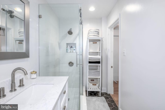 full bathroom featuring tile patterned floors, a shower stall, and vanity