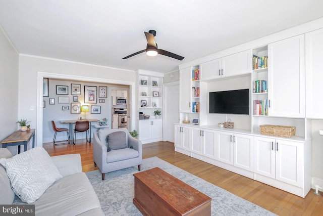 living room with light wood-style floors and a ceiling fan