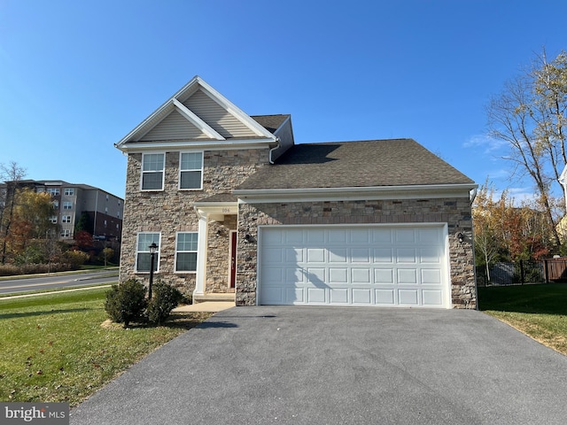 view of front of home with a garage, a shingled roof, a front lawn, and aphalt driveway