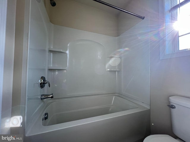 bathroom featuring toilet and bathtub / shower combination