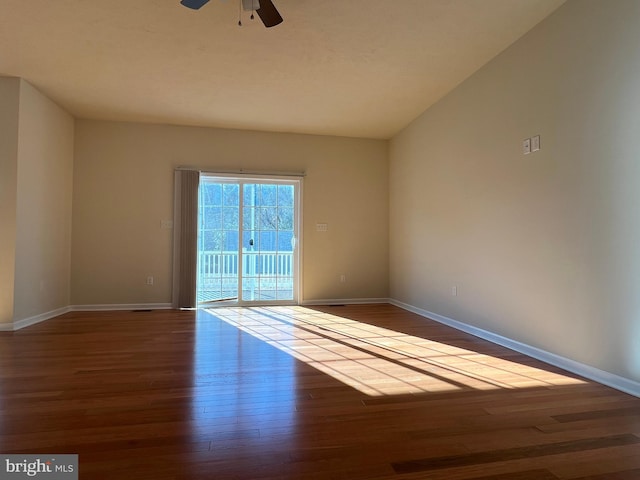 spare room featuring ceiling fan, baseboards, and wood finished floors