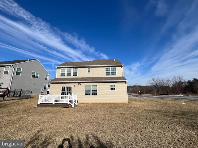 back of house featuring a deck and a yard