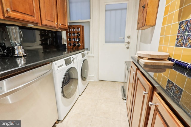 laundry area with light tile patterned floors, laundry area, and washer and dryer