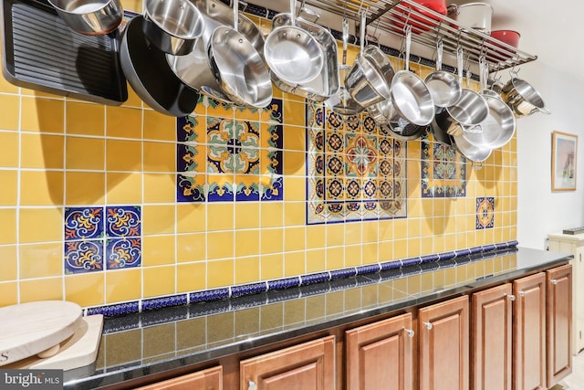 kitchen with brown cabinetry and dark countertops