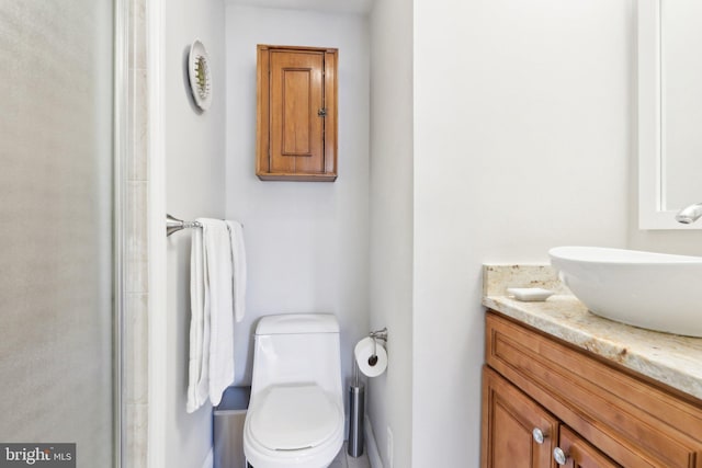 bathroom featuring vanity and toilet