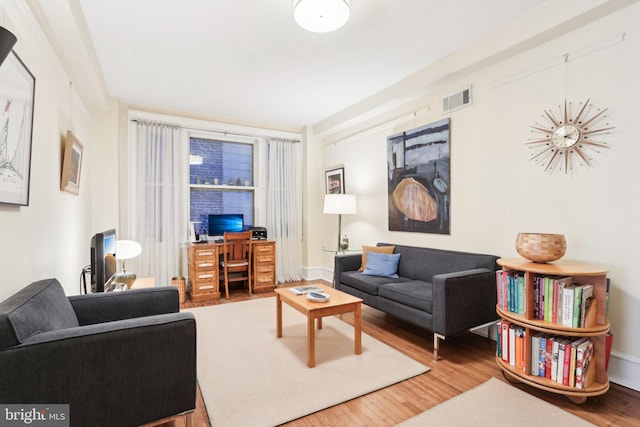 living room with wood finished floors and visible vents