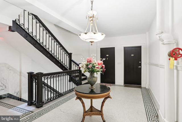 foyer entrance with baseboards and stairway