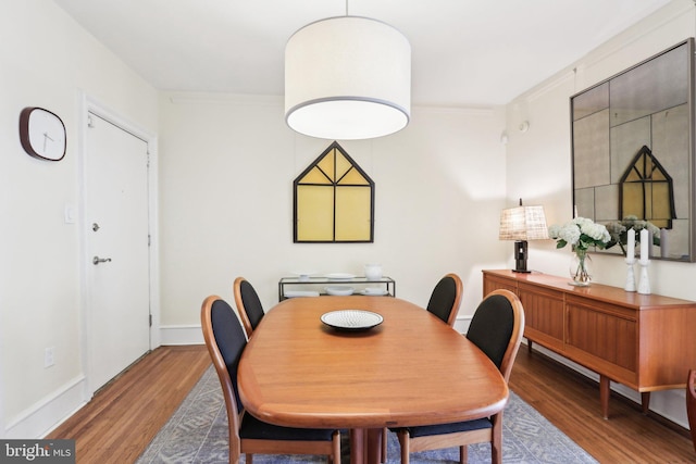 dining area featuring baseboards and wood finished floors