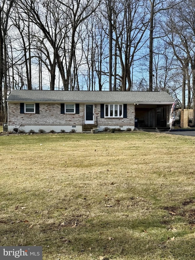 view of front of house with a front yard, crawl space, brick siding, and an attached carport