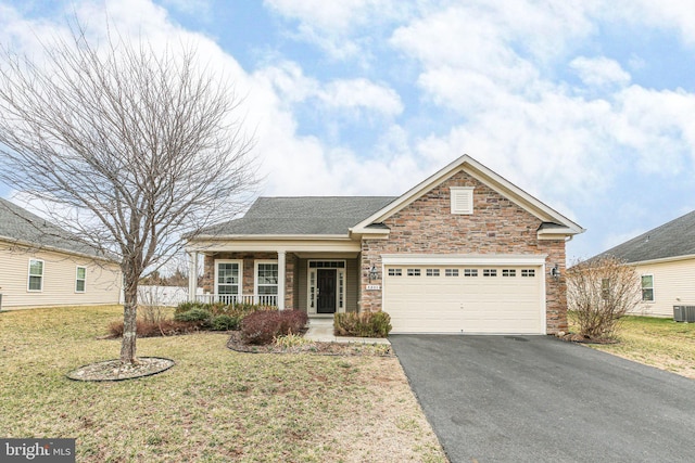 view of front of home featuring a front lawn, aphalt driveway, a porch, cooling unit, and an attached garage