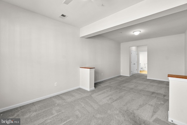 carpeted empty room featuring visible vents and baseboards