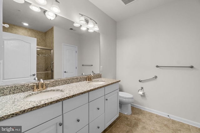 bathroom featuring baseboards, double vanity, a sink, and a shower stall