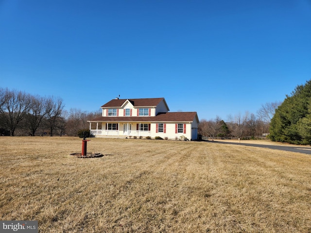 view of front of home with covered porch and a front yard