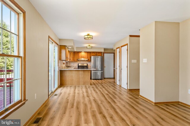 kitchen featuring stainless steel appliances, a healthy amount of sunlight, visible vents, and a sink