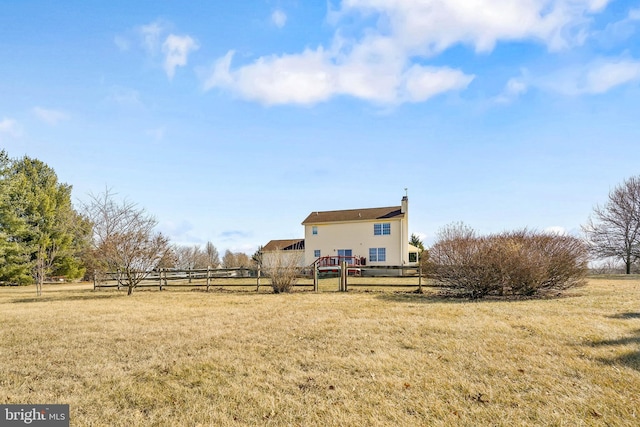 view of yard with a rural view and fence