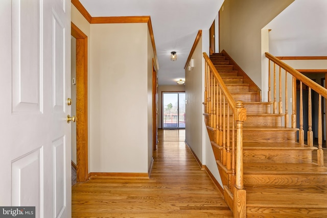 stairway featuring baseboards and wood finished floors