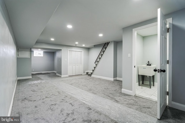 finished basement with recessed lighting, marble finish floor, baseboards, and stairs