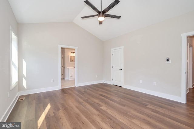 unfurnished bedroom with visible vents, baseboards, vaulted ceiling, and wood finished floors