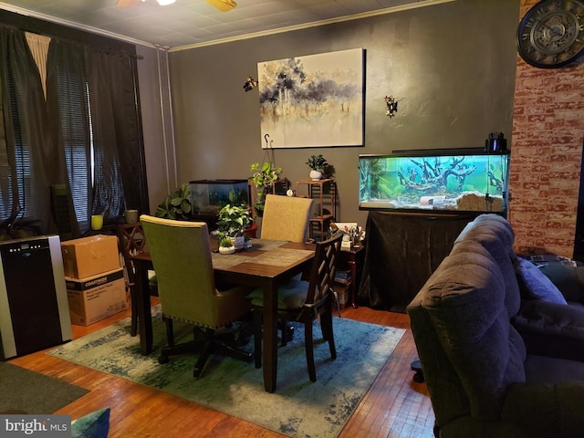 dining space featuring ornamental molding and wood-type flooring