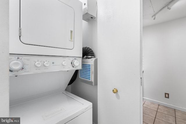 washroom with laundry area, stacked washing maching and dryer, and light tile patterned flooring