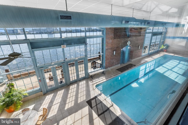 view of swimming pool with french doors