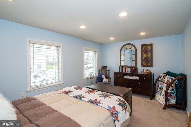 bedroom featuring light carpet and recessed lighting