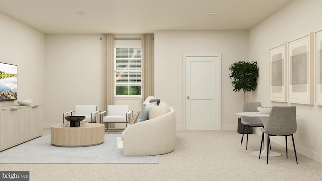 living area featuring light carpet and baseboards