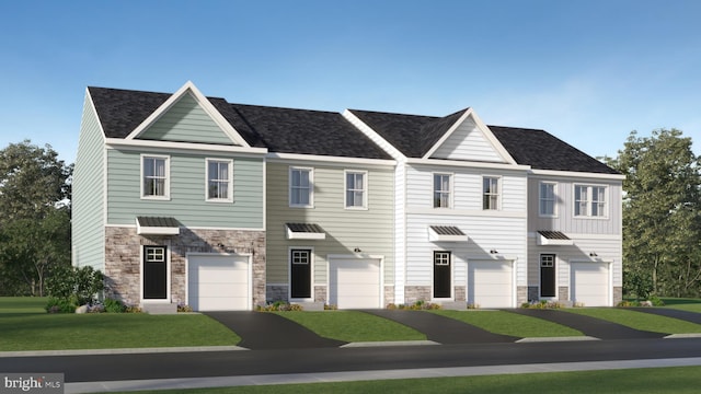 view of property featuring stone siding, an attached garage, and a front lawn