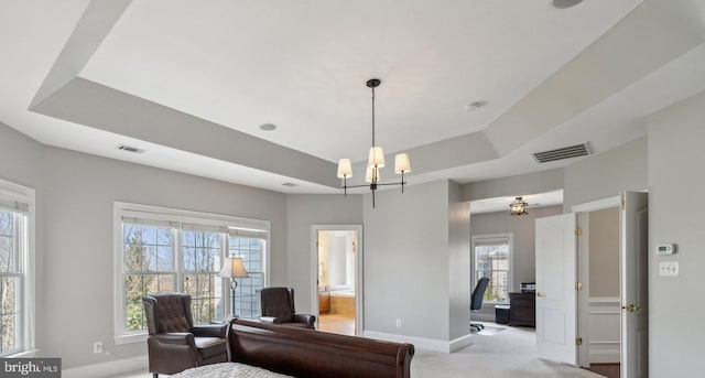 sitting room with light carpet, baseboards, visible vents, a raised ceiling, and an inviting chandelier