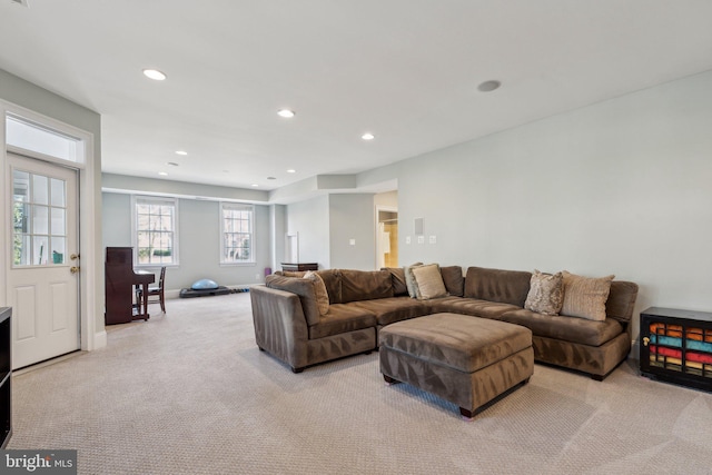 carpeted living area with recessed lighting and baseboards