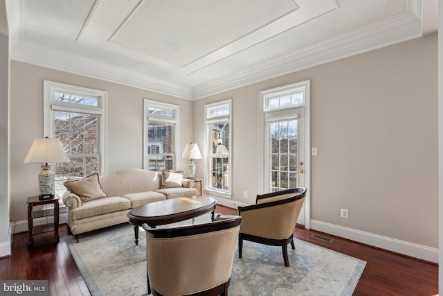 living area with crown molding, dark wood finished floors, a baseboard radiator, visible vents, and baseboards