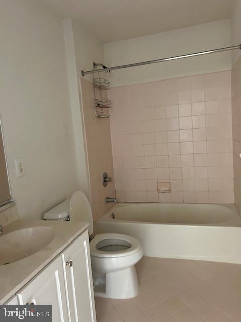 bathroom with toilet, tile patterned flooring, vanity, and washtub / shower combination