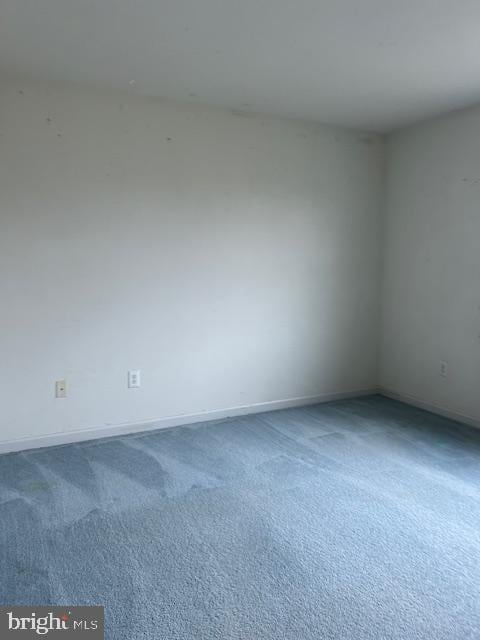 empty room with carpet and baseboards