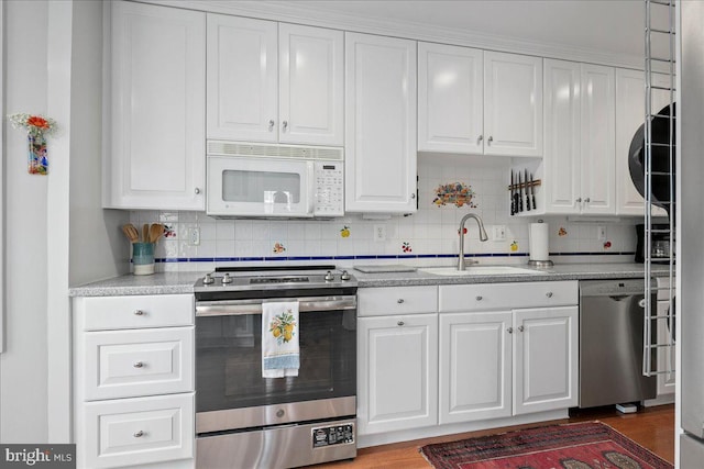 kitchen featuring white cabinetry, appliances with stainless steel finishes, and a sink