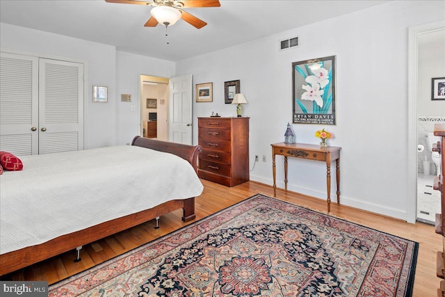 bedroom featuring ceiling fan, visible vents, baseboards, a closet, and light wood-type flooring