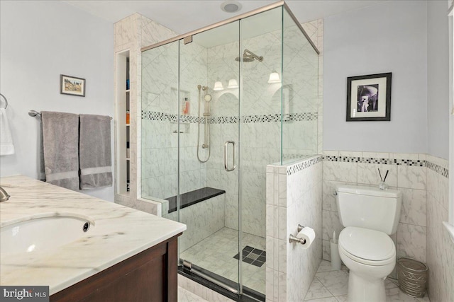 full bath featuring vanity, a shower stall, and toilet