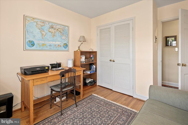 office with baseboards and wood finished floors