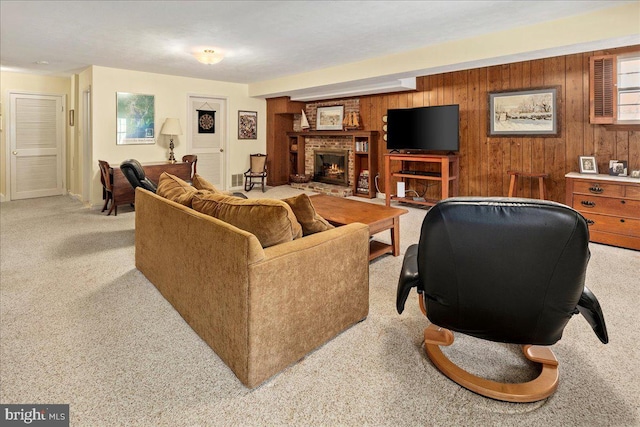 carpeted living room with wood walls and a fireplace