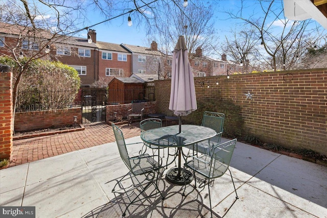 view of patio / terrace with outdoor dining space and fence