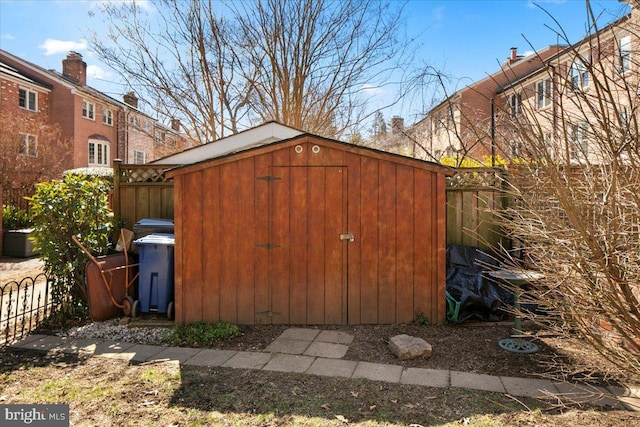 view of shed with fence