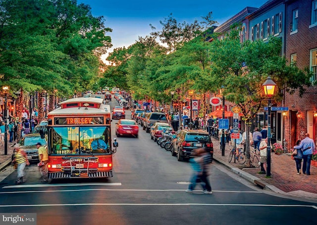 view of street featuring sidewalks, curbs, and street lights