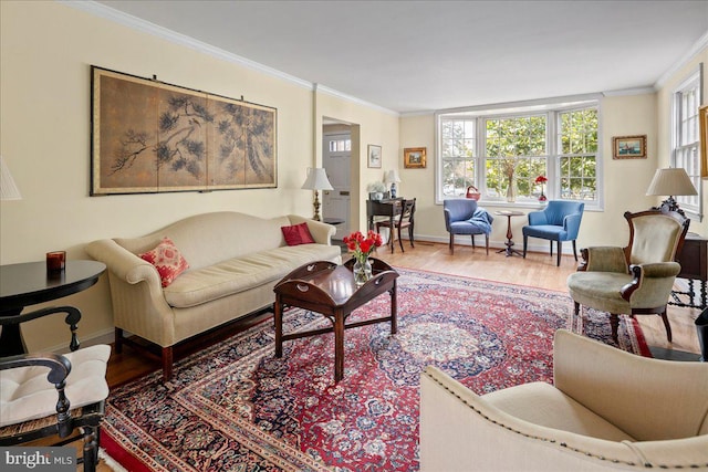 living room with baseboards, ornamental molding, and wood finished floors